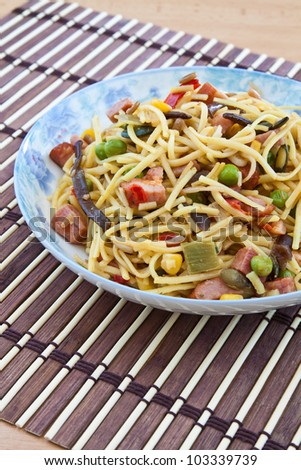 Yellow noodles cooked with Chinese vegetable mix and smoked bacon