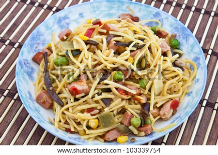 Yellow noodles cooked with Chinese vegetable mix and smoked bacon