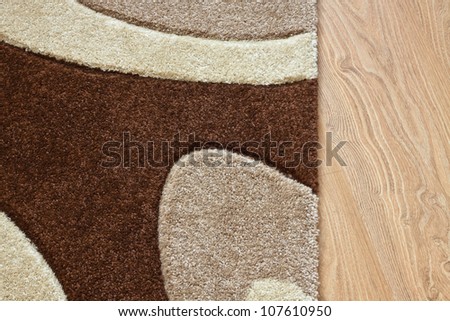 Detail of carpet in brown, beige and white colors on laminate