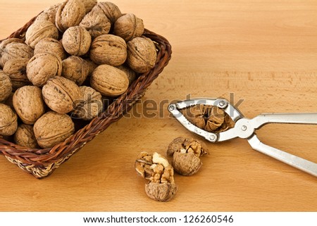 Group of walnuts with a broken appliance breaking shells