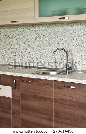 Detail of kitchen furniture with an emphasis on contemporary ceramic mixer cusine