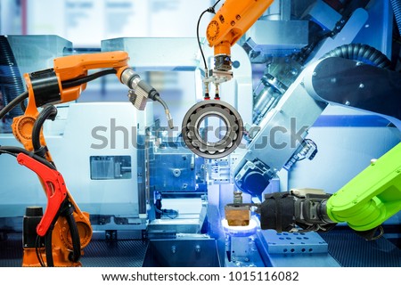 Industrial robotic welding and robot gripping working on smart factory, on machine blue tone color background, industry 4.0 and technology.