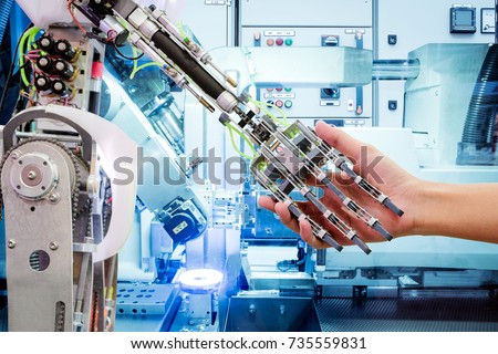 Artificial Intelligence handshake with humans on industrial robotics in blue tone color background, The robot has a role to work replacing humans in modern industries, industry 4.0 concept