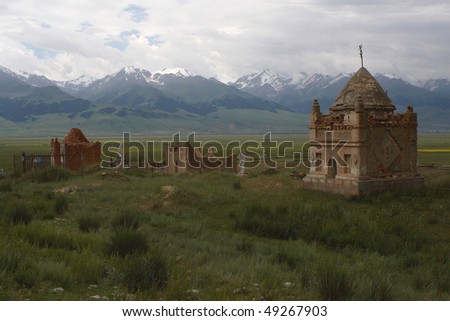 Ancient Kirghiz cemetery against mountains Tien Shans. The soul of the died will be released after a tomb the grave will destroy.