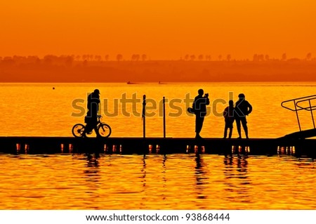 Family on vacation enjoying time on boardwalk at sunset