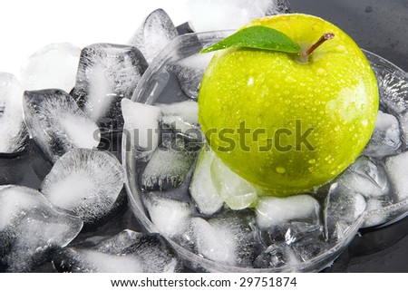 Green apple with leaf and the broken ice