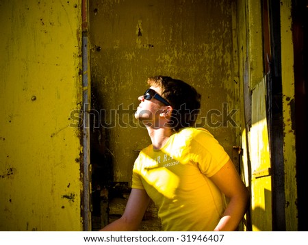 man sitting in the old yellow cabin