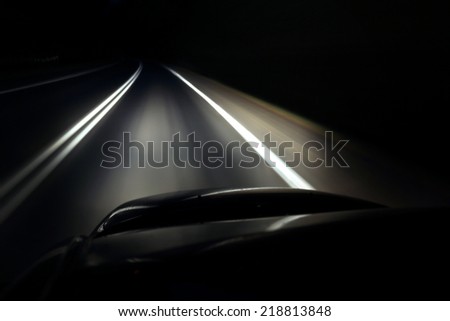 Lonely driving a car at night on the highway