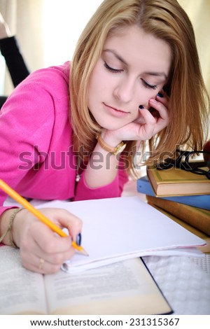 The girl writes a note in notebook