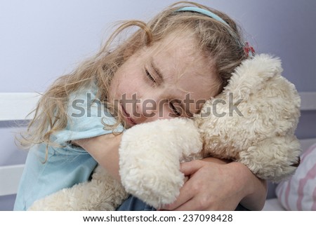 sad lonely girl sitting in the room hugging teddy