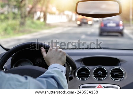 Driving car in the sunny streets of the city