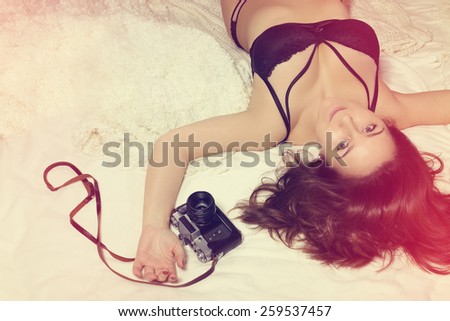 Sensual woman with old camera with vintage style