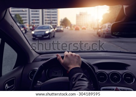 The driver goes a sunny streets in the city