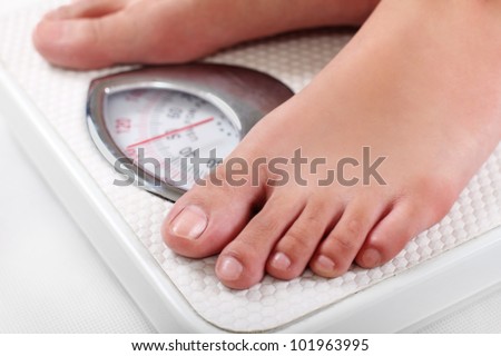 Feet on a weighing scale.Close up.