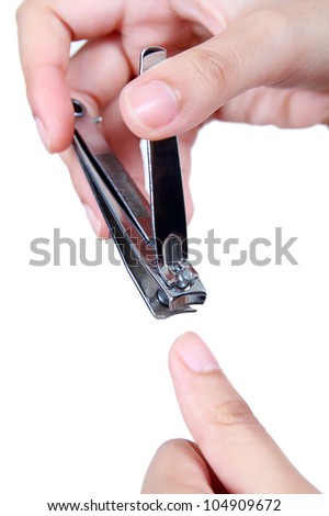 Close up image of hands clipping a nail.