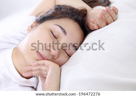 Close up of a young asian lady sleeping peacefully.