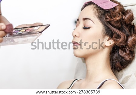 beautiful young asian lady preparing for make up in the beauty parlor.