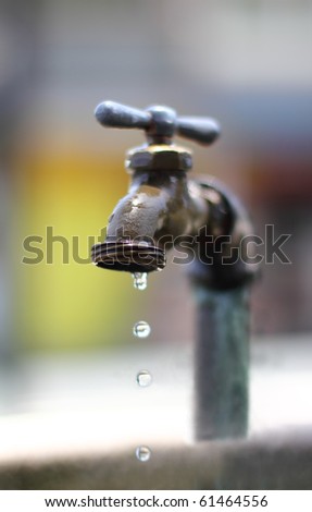 dripping water on an old faucet.narrow DOF