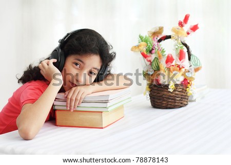 Young asian student listening to music