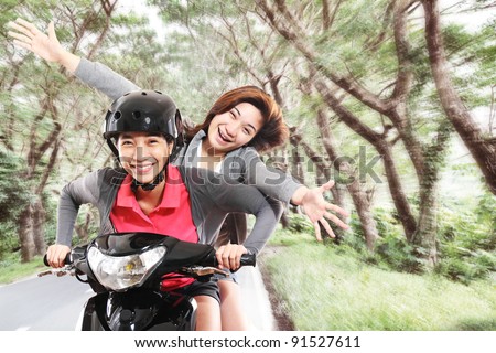 Girls having fun riding a motorcycle