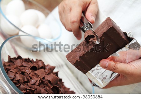 Chef preparing chocolate flakes for baking.Close up.