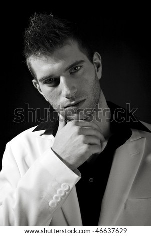 Sexy man in white suit on black background - B/W with analog grain
