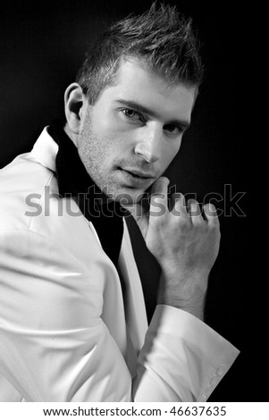 Sexy man in white suit on black background - B/W with analog grain