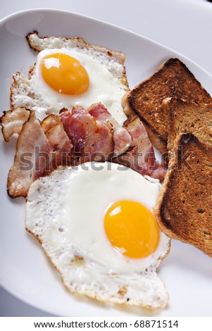 Breakfast - roasted toasts, eggs, bacon