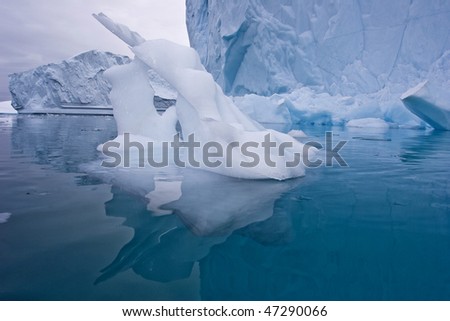 a piece of ice sculptured by the wind and water in east greenland