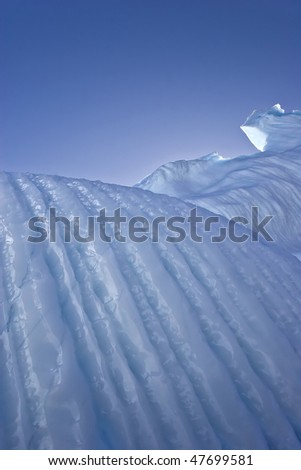 a giant iceberg sharpened by wind and water in greenland