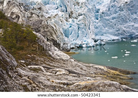 a glacier enters the water in the beagle channel, patagonia