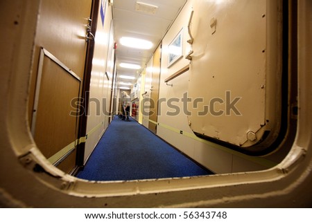 a member of the crew staff cleaning the carpets in the cabins area aboard a cruise ship
