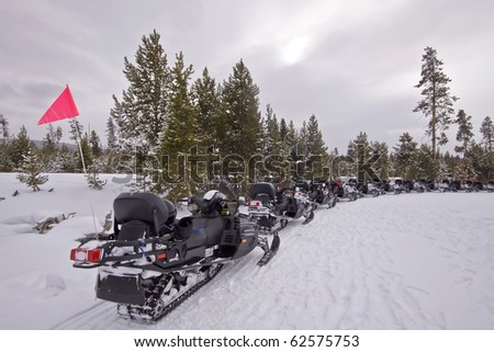 snow mobiles waiting for a ride on the snow of yellowstone