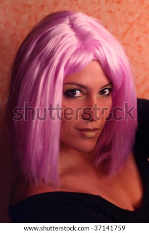 funny portrait of lovely girl with green make-up and pink wig