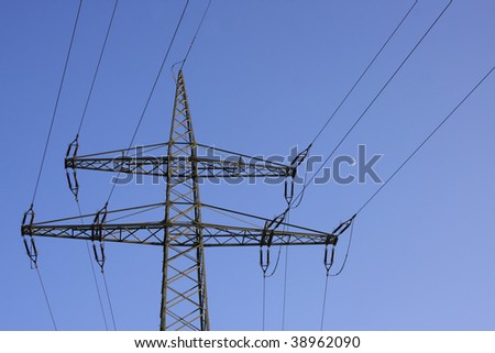 Electrical power mast in front of the moon