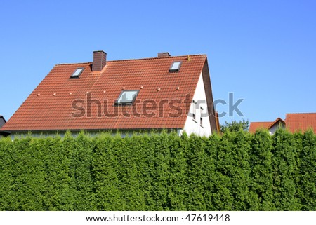 Residential building behind hedges
