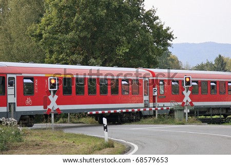 Regional train travels over a level crossing