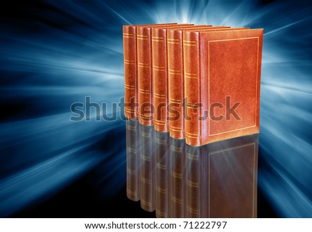 five brown leather books on abstract dark blue background