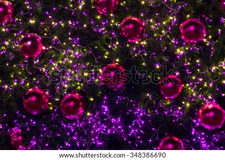 decorated christmas tree with pink balls and colorful light