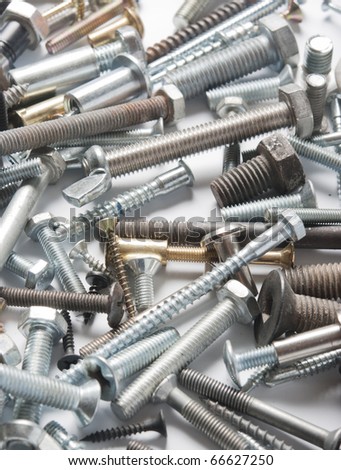 Many types of metal bolts, with some copy space.