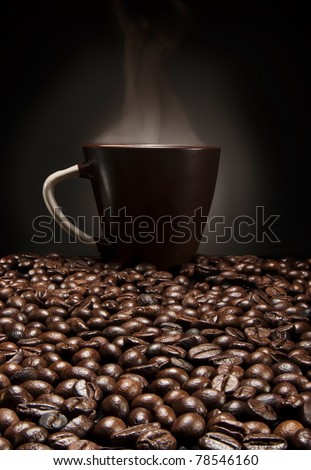 brown cup of coffee with beans over gradient background