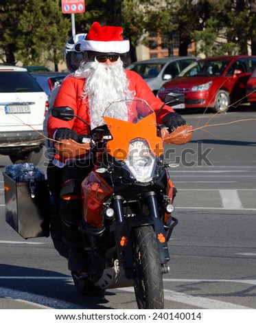 BELGRADE, SERBIA - DECEMBER 27:  Undefined Santa delivering humanitarian aid in form of gifts to disabled children during annual Santa Claus Motorcycle Parade on 27 December 2014 in Belgrade, Serbia
