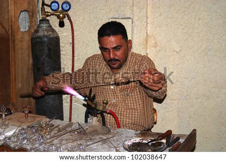 KARNAK,EGYPT-NOV. 27: Demonstration of making a bottle of perfume from a molten glass on November 27 2009, Karnak, Egypt. From the earliest times, Egyptians have worked with glass,