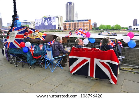 LONDON - JUNE 01: Unidentified people sleep in a tent alongside the River Thames to witness Thames Diamond Jubilee boats parade on June 1, 2012 in London.