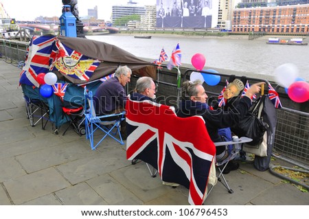 LONDON - JUNE 01: Unidentified people sleep in a tent alongside the River Thames to witness Thames Diamond Jubilee boats parade on June 1, 2012 in London.