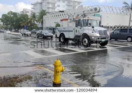 MIAMI - SOUTH BEACH - FLORIDA, OCTOBER 28:  Electricity truck cross Miami South beach Lenox Ave flood aftermath of Hurricane Sandy on october 28 2012 in Miami South Beach.