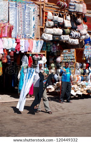 KARNAK EGYPT NOVEMBER 26:Men sale souvenirs in typical street market on november 26 2009 Karnak Egypt. More than 20 percent of Egypts 76 million people live below the poverty line.