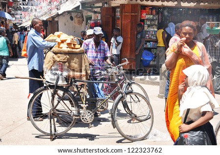 ZANZIBAR, TANZANIA-NOV. 24: An unidentified street seller sells fresh bread in Zanzibar, Tanzania on Nov 24, 2011. According to UNICEF, gross national income (GNI) for Tanzania in 2007 is USD$ 720
