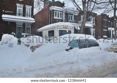 MONTREAL-CANADA DEC. 27:Cars cover of snow on Merose Street. The snow storm slam Montreal with 45 cm of snow, Canada on December 27, 2012 after knocking out power to thousands of homes in the U.S..