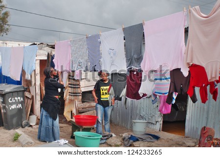 CAPE TOWN SOUTH AFRICA MAY 23: Women hang their clothes in Khayelitsha township on may 23 2007 in Cape Town South Africa It is reputed to be the largest and fastest growing township in South Africa